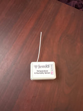 Temperature and humidity sensor on a wooden surface