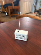 JemRF device on a wooden surface with a blurred background