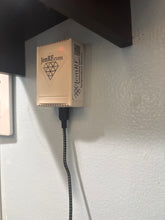 Small electronic device with a cable on a light-colored surface